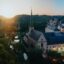 View of Luxembourg city, a green area near a body of water and old-looking buildings. Get in a Luxembourg airport taxi and start exploring.