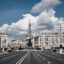 thick white clouds in the blue sky, spreading over city buildings