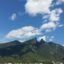 Green mountain peak under a blue sky with bold white clouds. Take a taxi from Monterrey airport and start exploring. Monterrey Airport guide