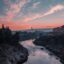 body of water between rocky formations under a colourful sunrise sky