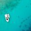 clear turquoise water from above, with two small white boats