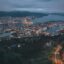 Aerial view of Bergen city in the evening when the sun has gone down and all the city lights are illuminated. Enjoy the evening in the city by taking a taxi from Bergen Airport to your hotel