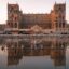 Image of Baku city centre, with a large classical building in front of a body of water.
