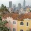 Old houses with new skyscrapers in the background and grey skies above, Bogota, Colombia.