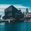 An image of Canning Dock from the River Mersey, with large glass buildings lining the water and older, traditional buildings behind.