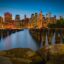 View of New York City at sunset with skyscrapers in the background.