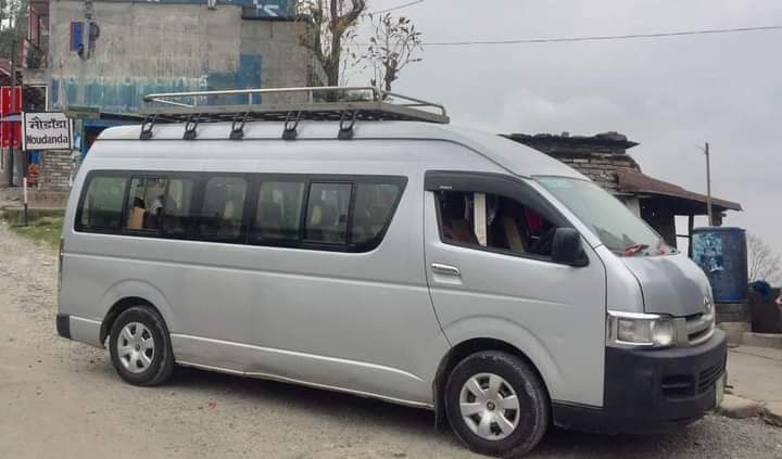 A silver minivan serving as a private Kathmandu Airport taxi
