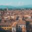view above Lucca, Italy under a blue sky with the hills in the background