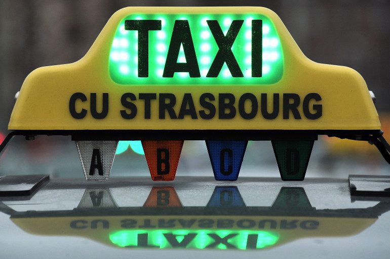 Strasbourg taxi with an illuminated sign on the roof.