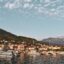 View of the marina of Tivat with boats and mountains in the background. Tivat taxi services are available nearby.