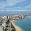 Aerial view of Punta del Este, a cityscape surrounded by clear water and long white-sand beaches.