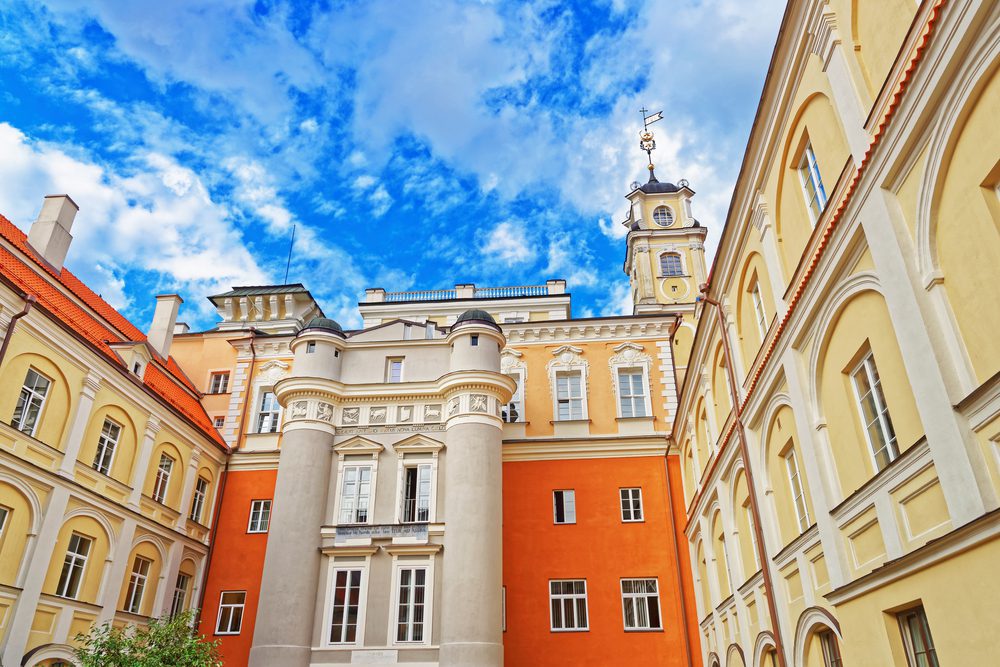 Beige, cream and orange classical buildings with blue skies above.