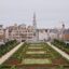 View of a garden with walkways either side and classic buildings at the end.