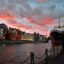 Pink cloudy sunset over the channel and homes in Gdansk, Poland.