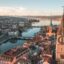 A view over Zurich city with old churches and buildings set along the banks of a river.