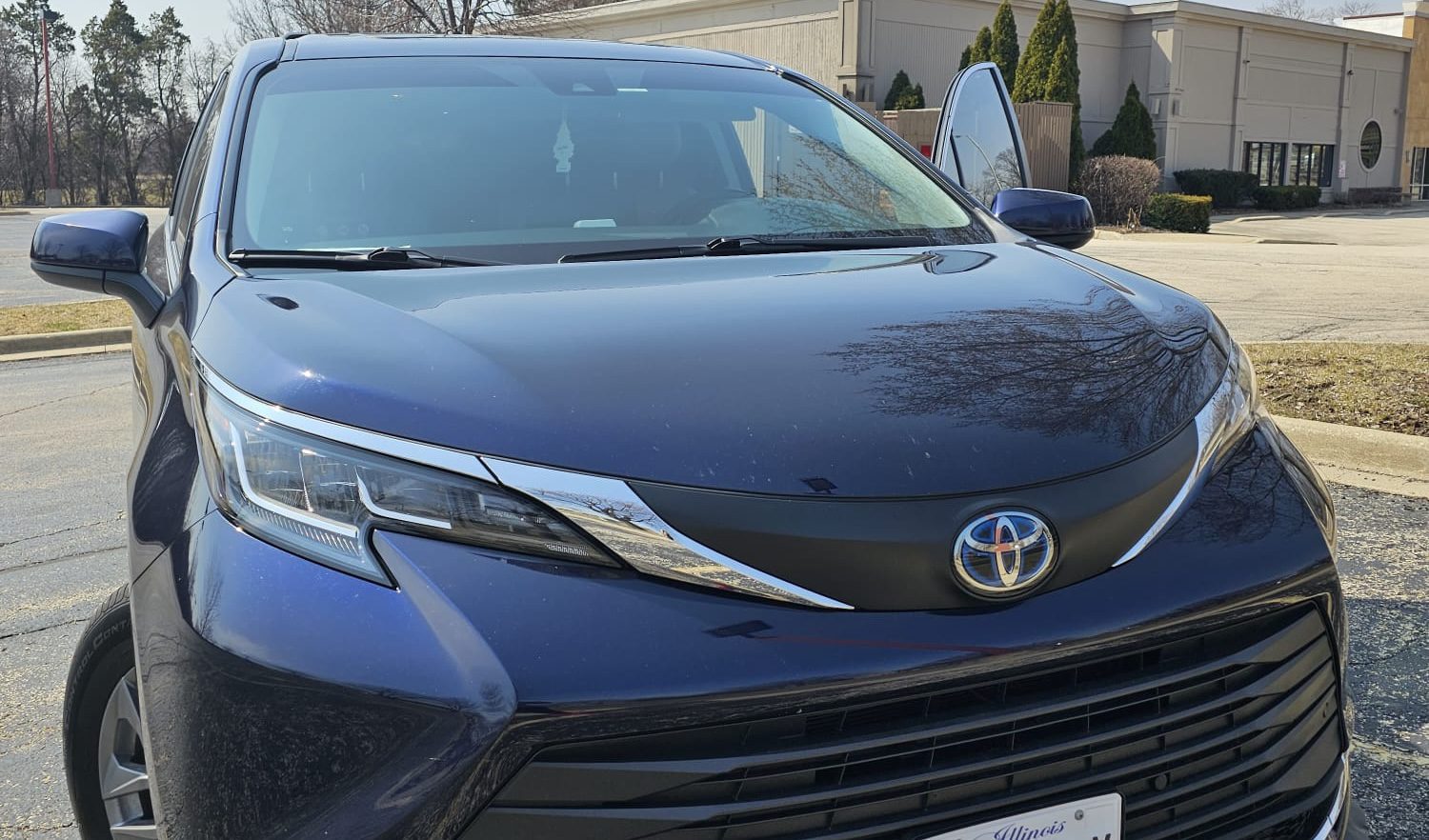 Chicago Airport Taxi (Minivan) by Welcome Pickups A dark blue Chicago Airport Taxi Minivan is scene parked in an outdoor location.
