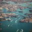 aerial view of dark green waters boats and buildings