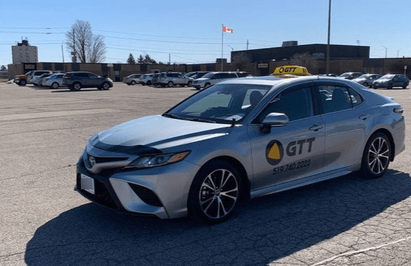 A silver taxi with the GTT logo.
