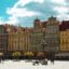 The main square in Wroclaw surrounded by quaint heritage buildings in yellows and browns.