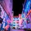 Buildings in Wroclaw lit up with colorful neon lights.