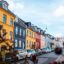 Aarhus street lined with homes and parked vehicles