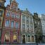 A street of colourful heritage buildings with block windows