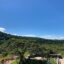 View of a green hillside against a blue sky in Liberia Costa Rica