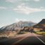 a road in Mendoza Argentina with a mountain in the background