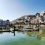 A view of Agadir jetty surrounded by houses and apartment blocks with boats moored on the water in Moracco