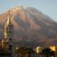 Ornate steeple with a mountain in the background from Arequipa, Peru.