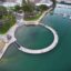 Aerial view of docks and roadways along a waterway.