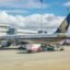 Airplane sits at a gate at Perth Airport.