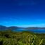 Rich blue sky over hillsides, water, and forest near Puerto Princesa, Philippines.