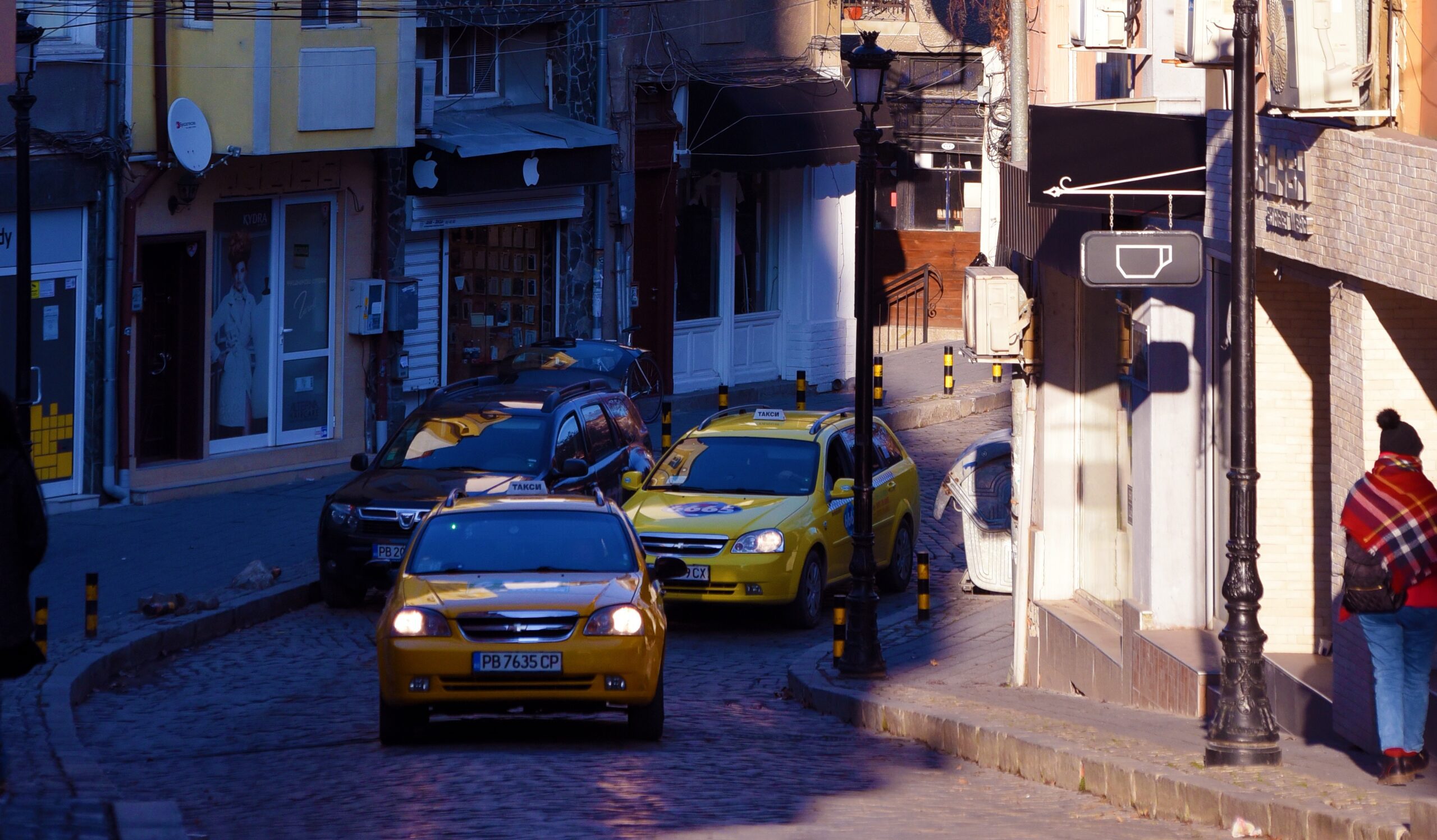 yellow taxi cars are driving down the street