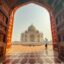 View from inside a structure looking outdoors to a tall, domed temple.