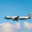 Close up of an Aegean plane flying in a cloudy sky during the daytime
