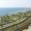 Coastal roadways, greenery, buildings, and trees line an ocean view.