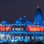 View of a colourful lit up building at night in Vrindavan, Uttar Pradesh, India.