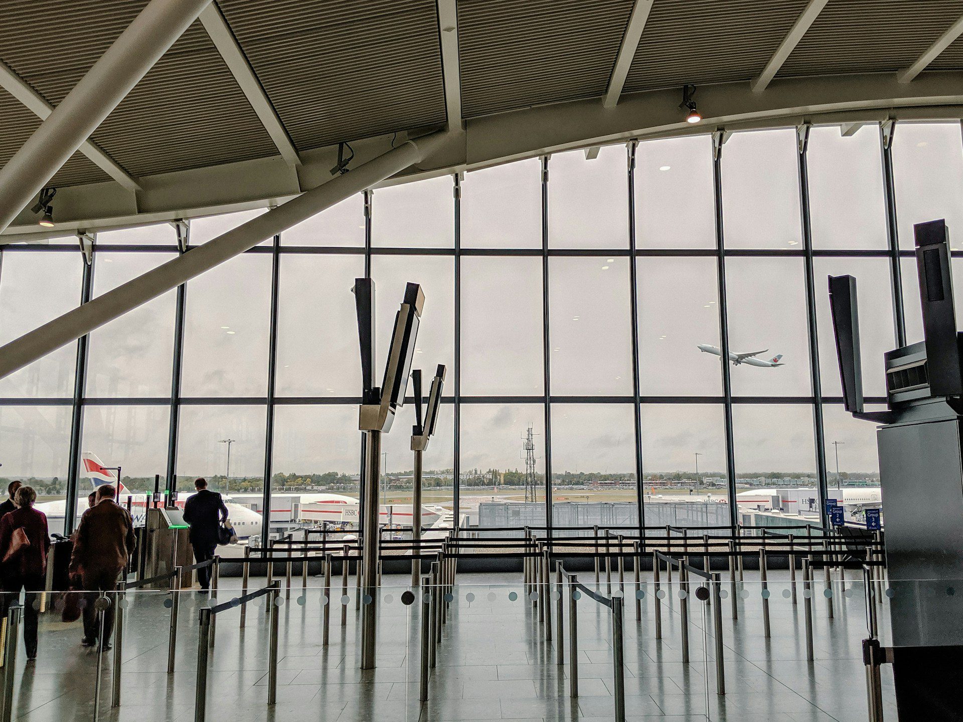 View of a plane in the sky from inside Airport terminal