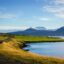 Coast of Akureyri waters mountains and sky.