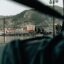 View from inside a window looking to a bay in front of buildings and hills in Lesvos.