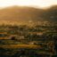 Golden tinted photo of the hills and rural homes in Vasiliki, Greece.