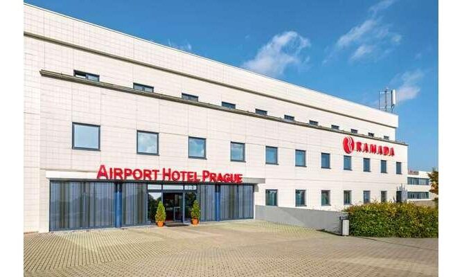 Exterior of the Ramada by Wyndham Airport Prague, with blue skies above.