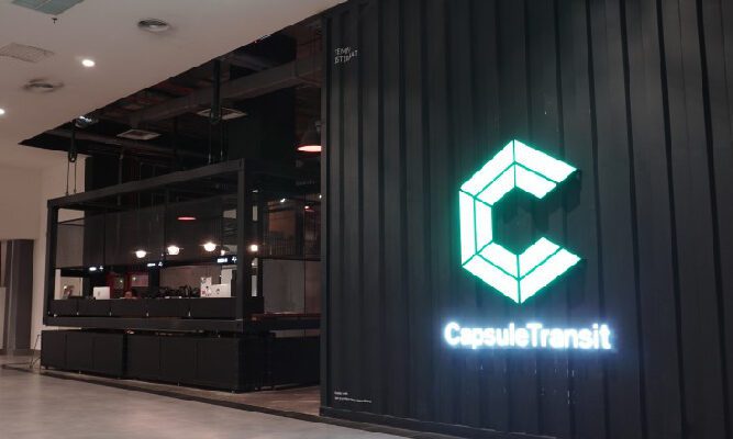 A blue neon sign highlighting the entrance to the Capsule Transit KLIA T2 Hotel.