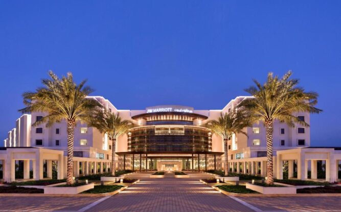 palm tree lined entrance to JW Marriott Hotel Muscat