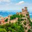 An immense castle fortress situated on the top of a hill in San Marino.