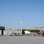 A front view of the main terminal building at Granada Airport, with a plane parked on the right side and blue skies above.
