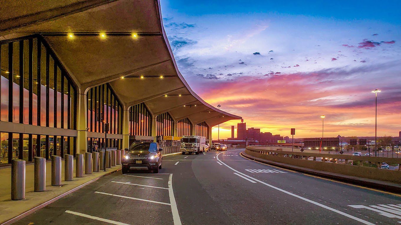 blue pink and yellow sunset seen outside of newark airport dropoff area