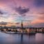the waterways and ornate buildings of Stockholm under a brilliantly purple sunset sky