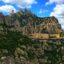 View of Montserrat with mountains behind and blue skies above.